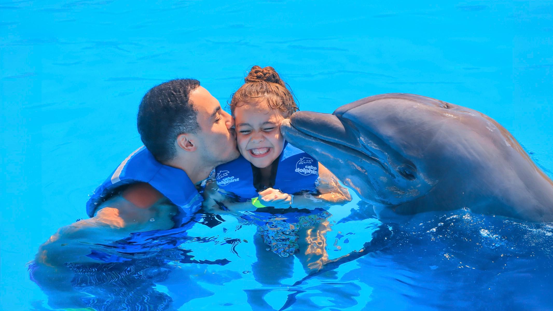 Family receiving a dolphin kiss during the Cabo dolphin experience